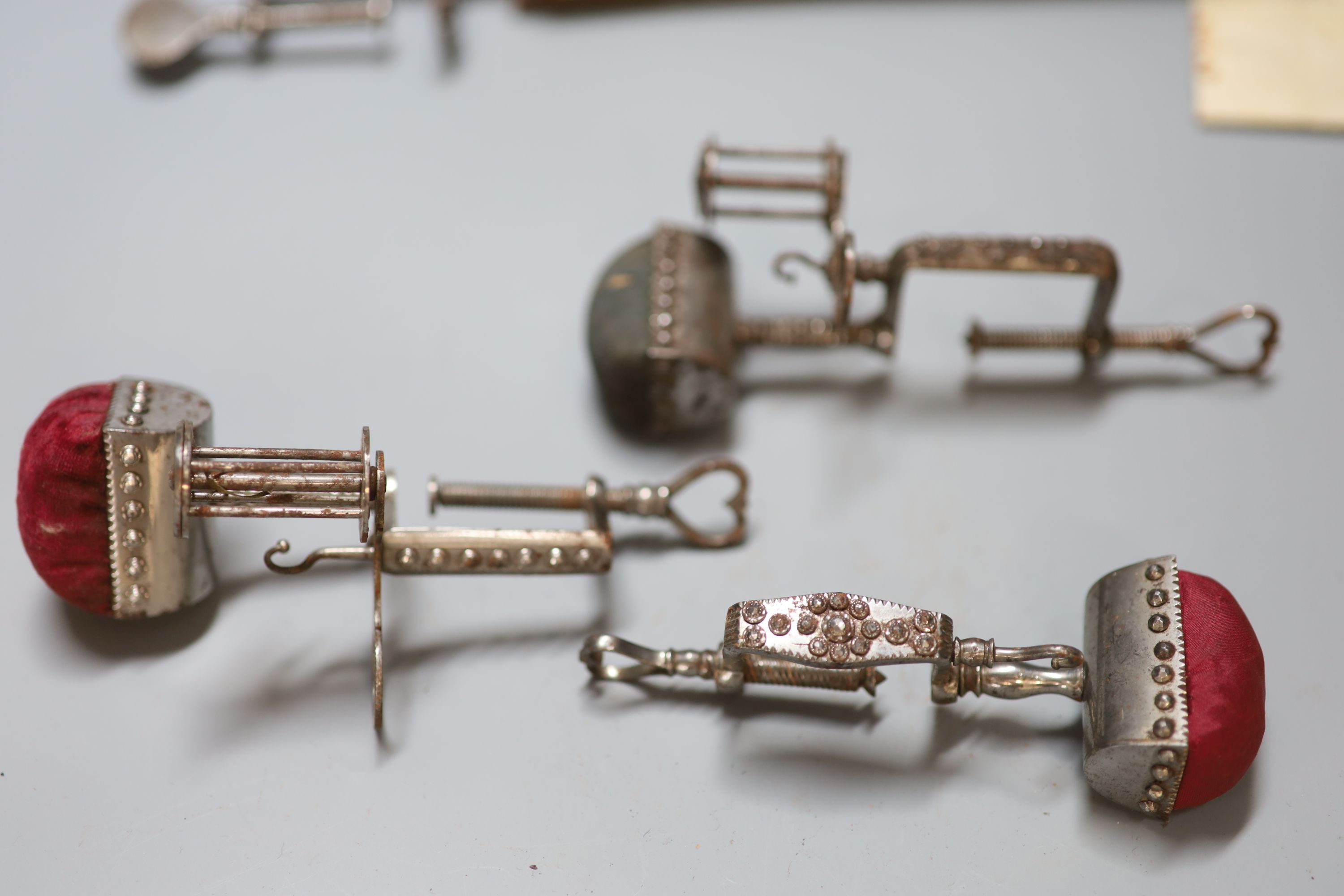 Four assorted early 19th century steel sewing clamps